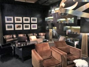 a room with brown chairs and a black wall