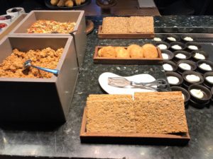 food on a counter with plates of food