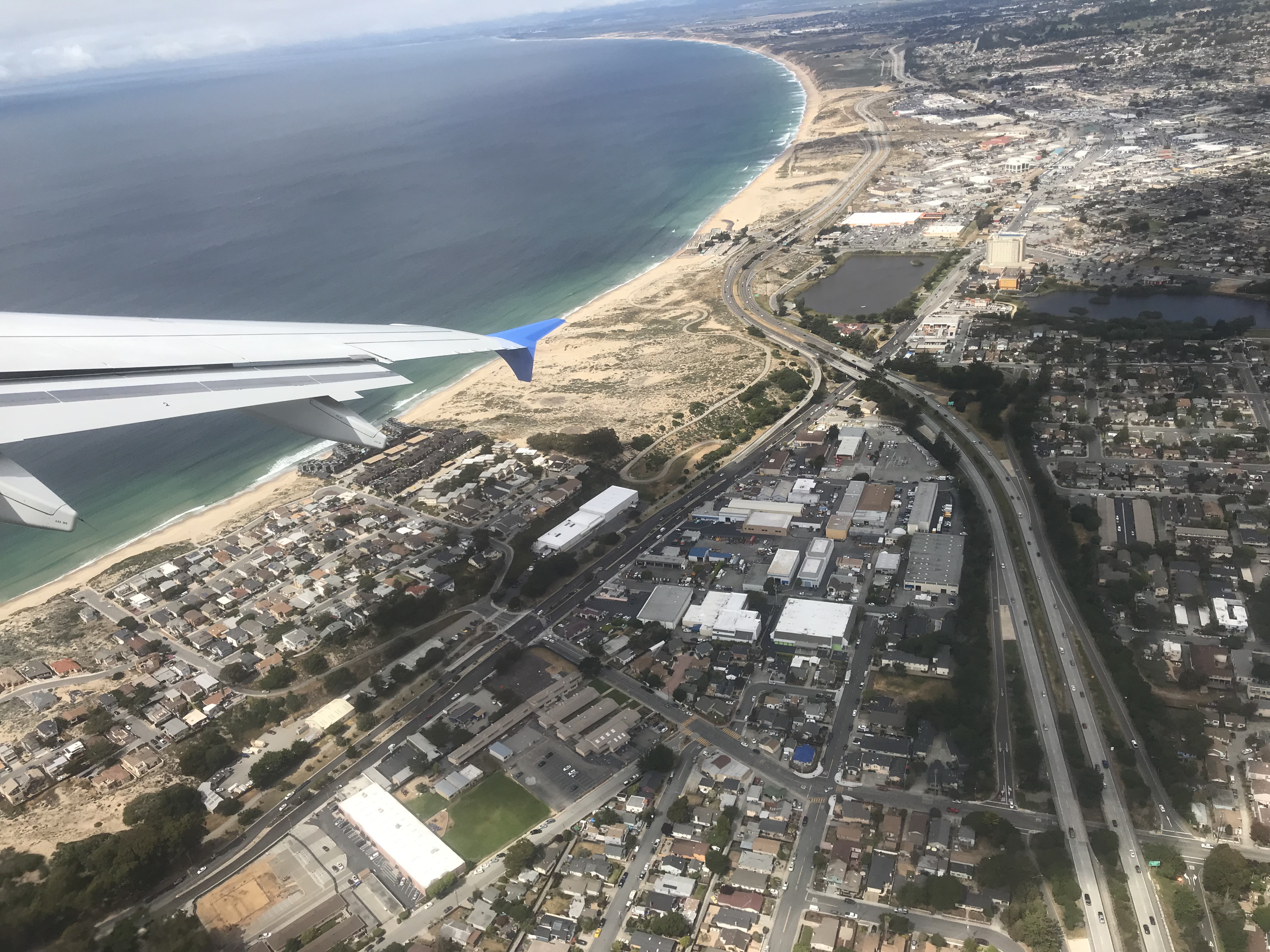 an airplane wing over a city