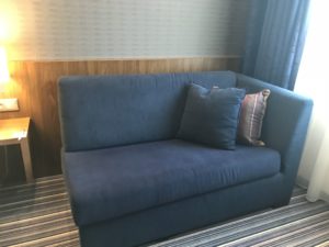 a couch with pillows in a room