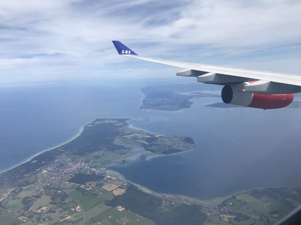 an airplane wing and land and water