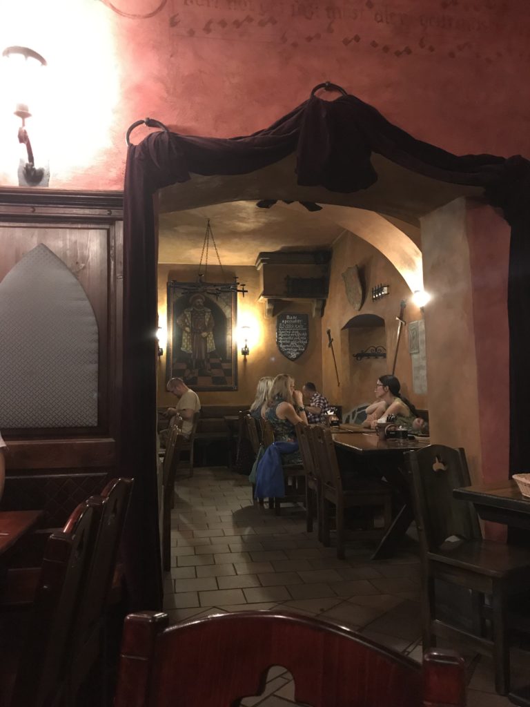 a group of people sitting at tables in a restaurant