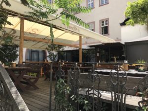 a wooden deck with tables and chairs