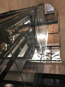 a glass railing with a metal railing