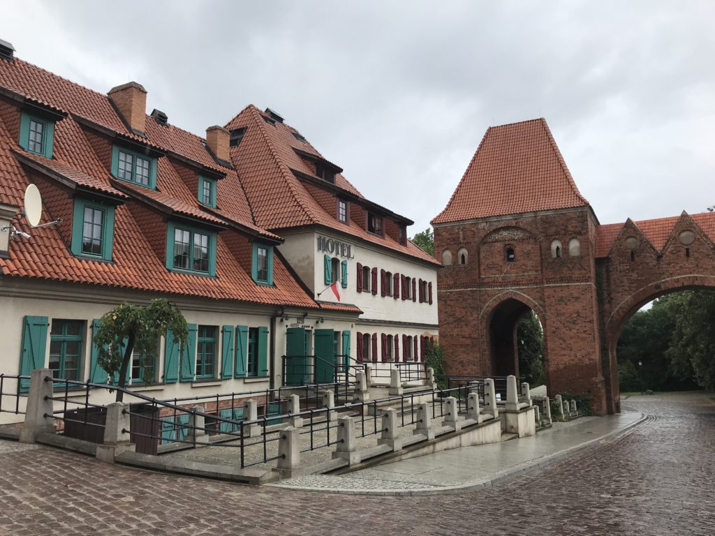 a brick building with a gate and a brick archway