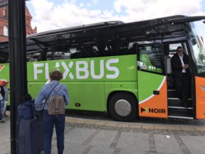 a green bus with white text on it