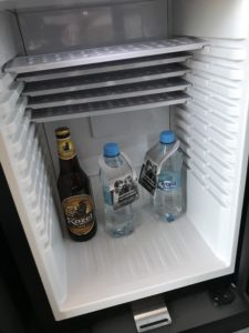 a refrigerator with bottles of beer and bottles of liquid inside