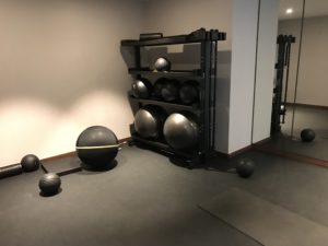 a shelf with exercise balls on it