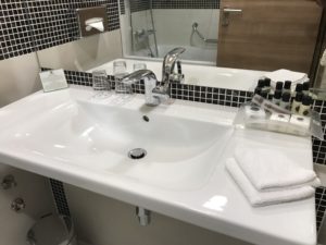 a sink with a faucet and a mirror