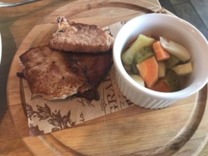 a plate of food on a wooden surface