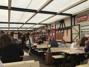 a group of people sitting at tables in a restaurant