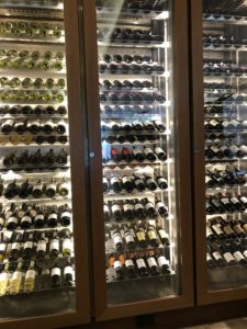 a glass case with bottles of wine