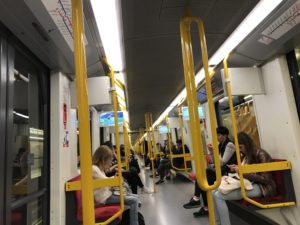 people on a train with yellow poles