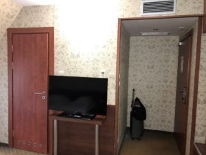 a room with a television and a door