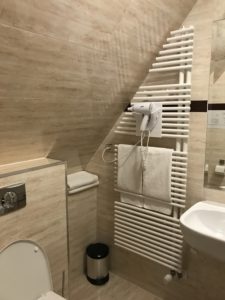 a bathroom with a white towel rack
