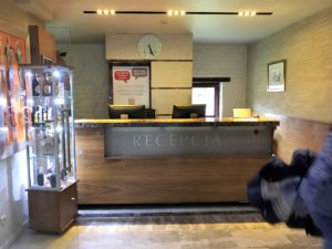 a person walking in front of a reception desk