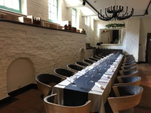 a long table with black and white tablecloths and chairs