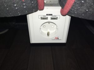 a white outlet with a black and red cord