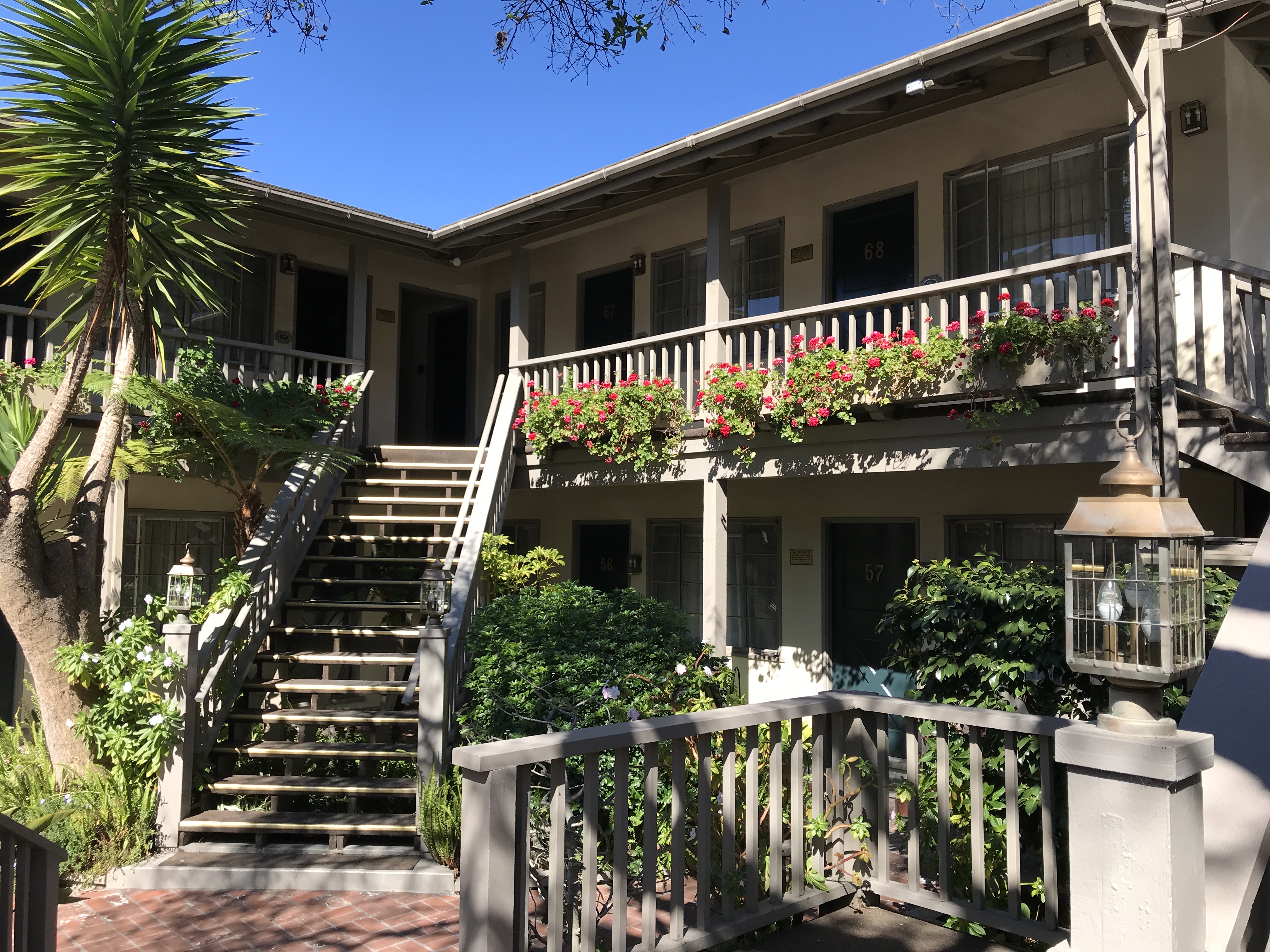 a building with stairs and plants