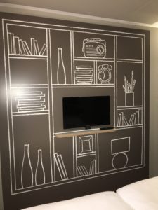a wall with a tv and shelves drawn on it