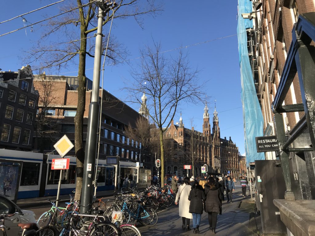 a group of people walking on a sidewalk