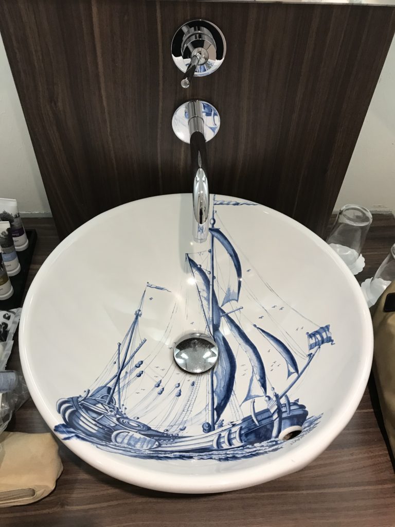a sink with a boat painted on it