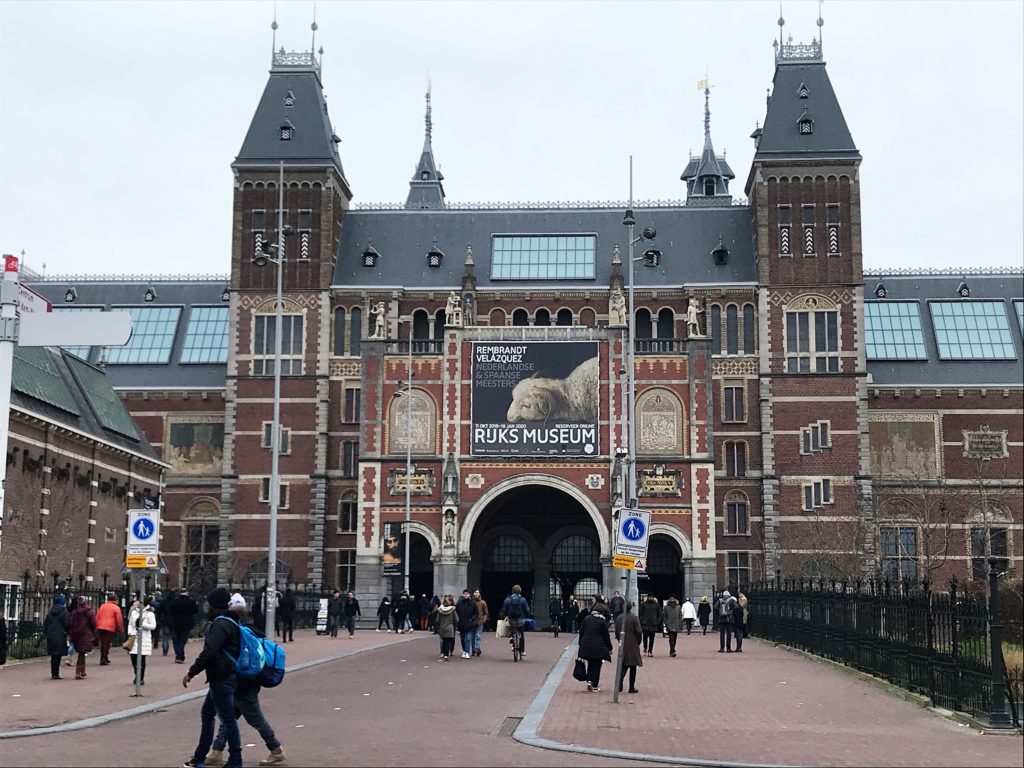 Rijksmuseum with many towers and people walking around