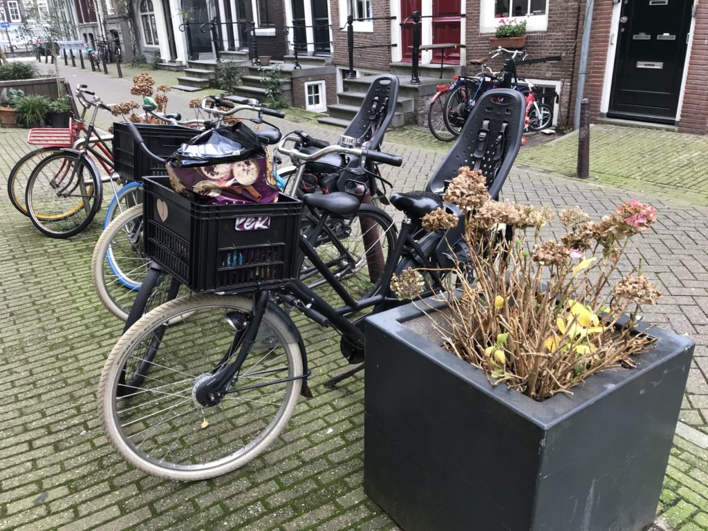 a group of bicycles parked on a brick sidewalk