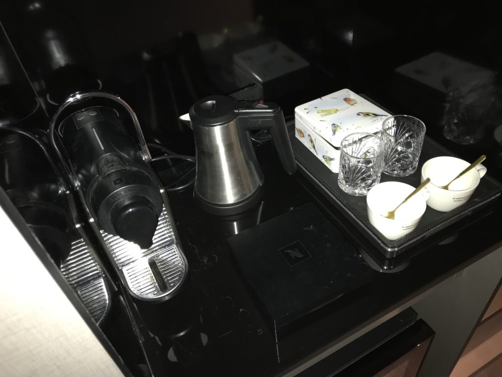 a coffee machine and cups on a black surface