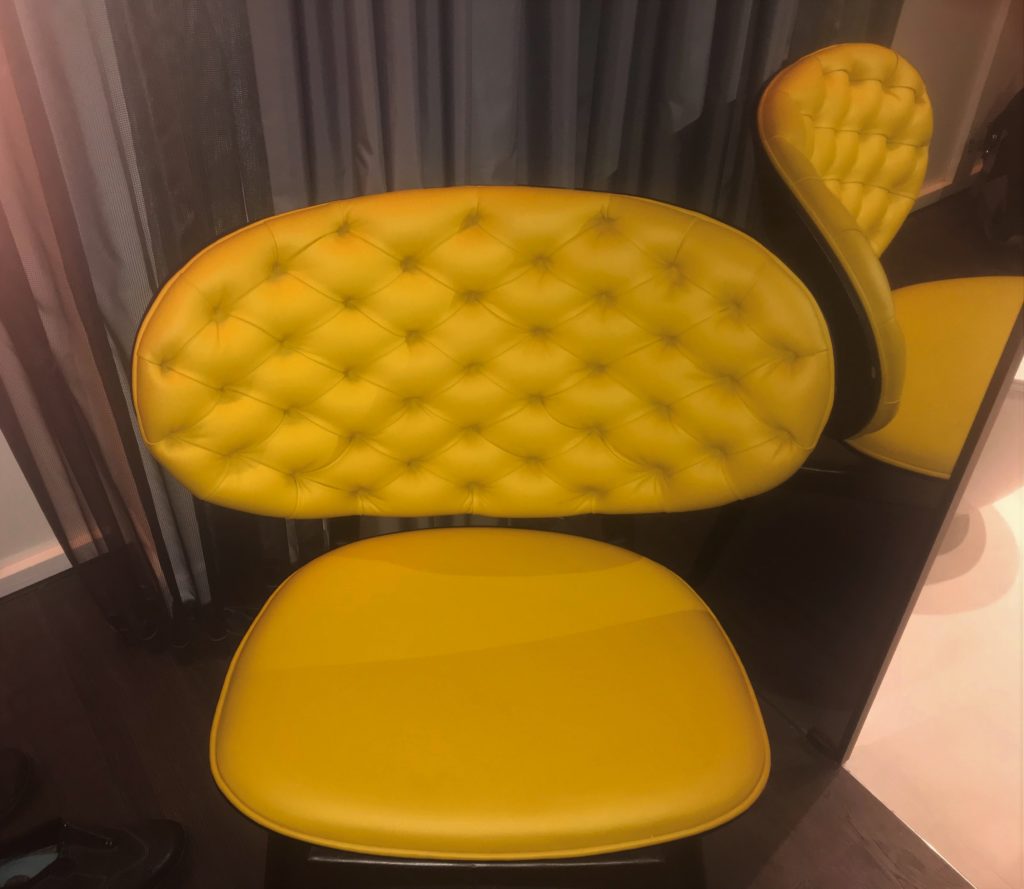 a yellow chair in a room