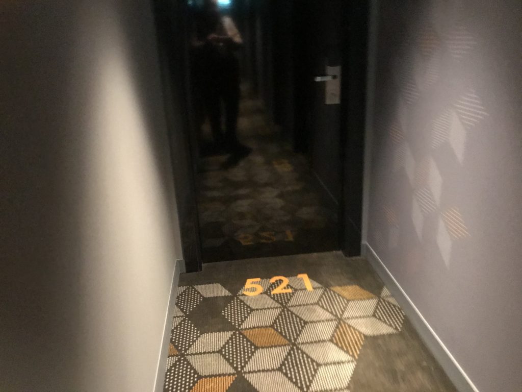 a hallway with a door and carpet