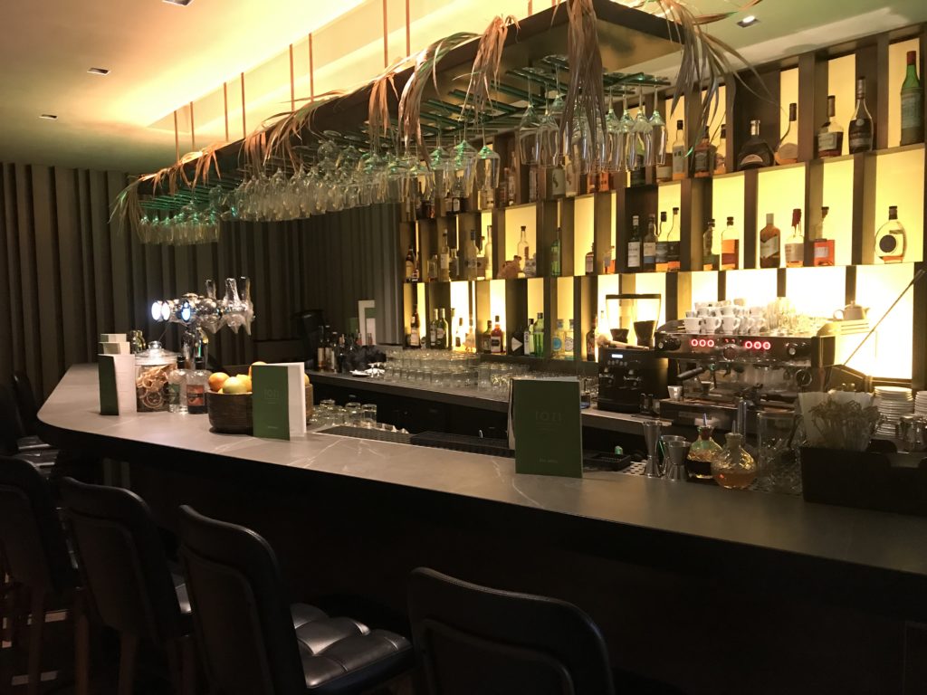 a bar with glasses from the ceiling