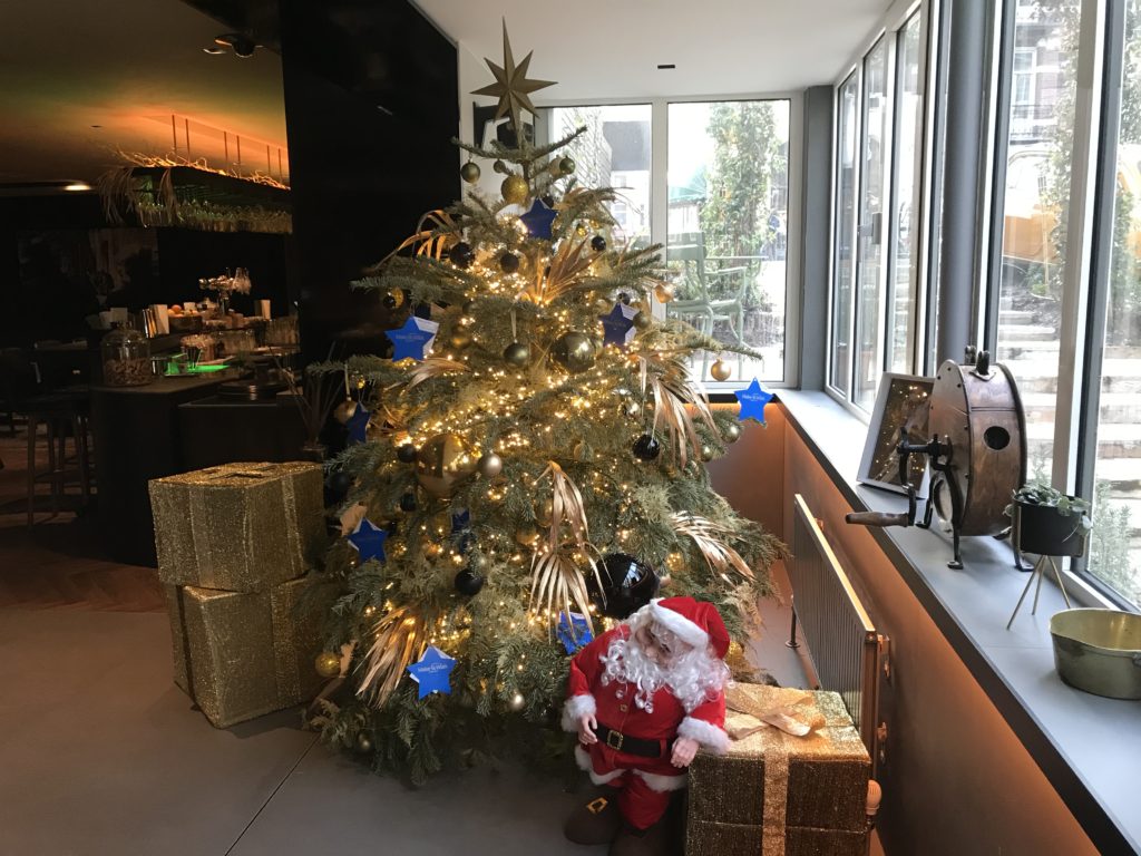 a christmas tree with presents and a santa claus