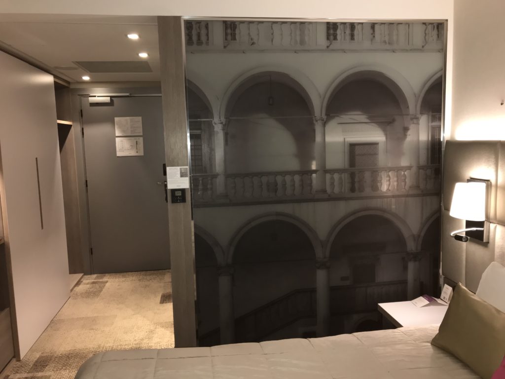 a room with a door and a picture of a balcony