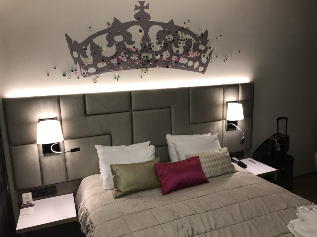 a bed with a crown on the wall