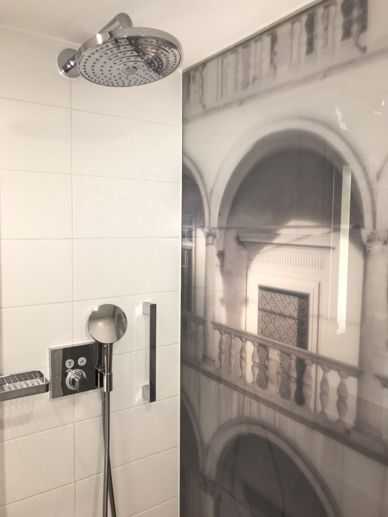 a shower head with a picture of a building