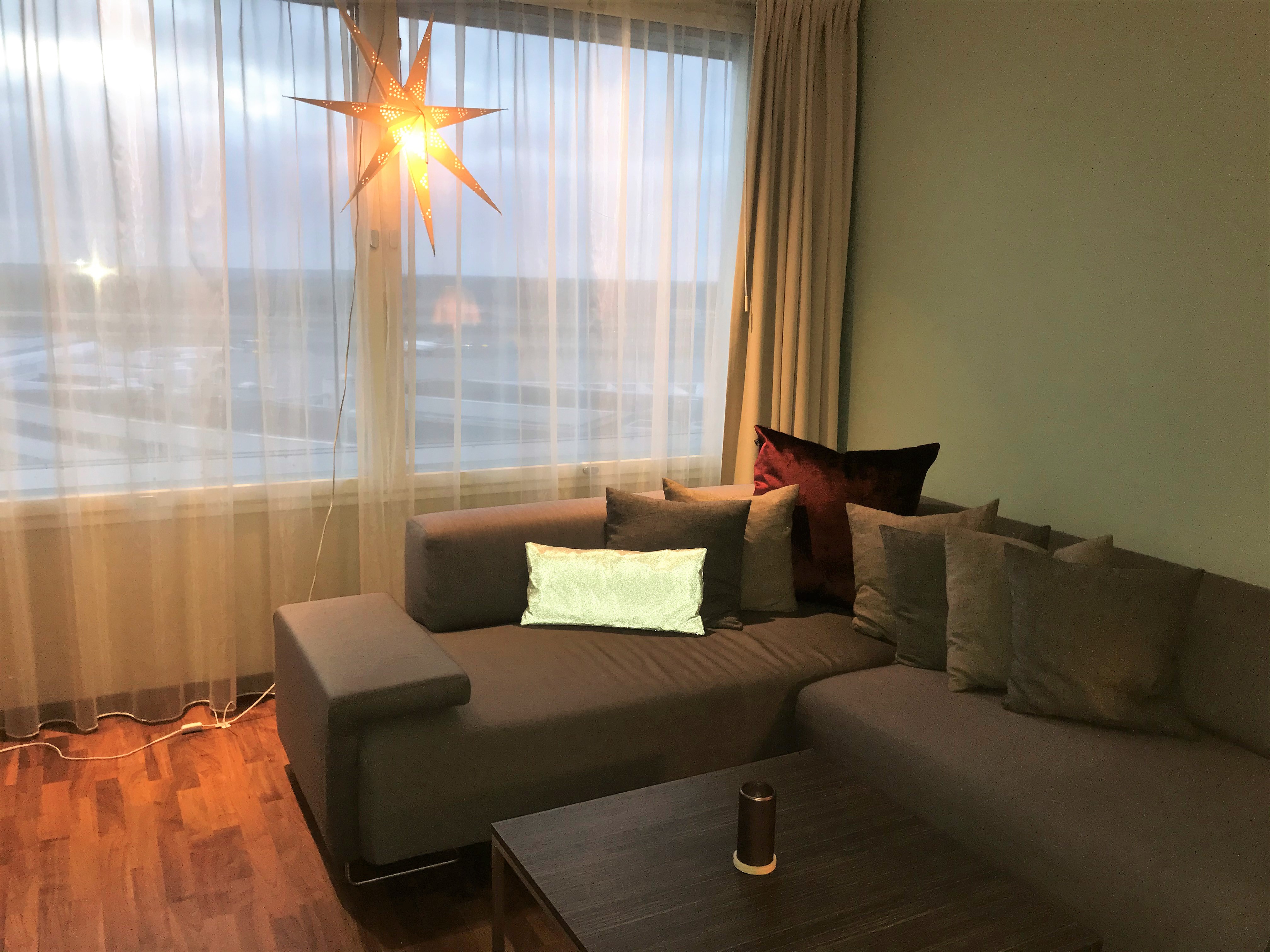 a couch and coffee table in a room with a star shaped light