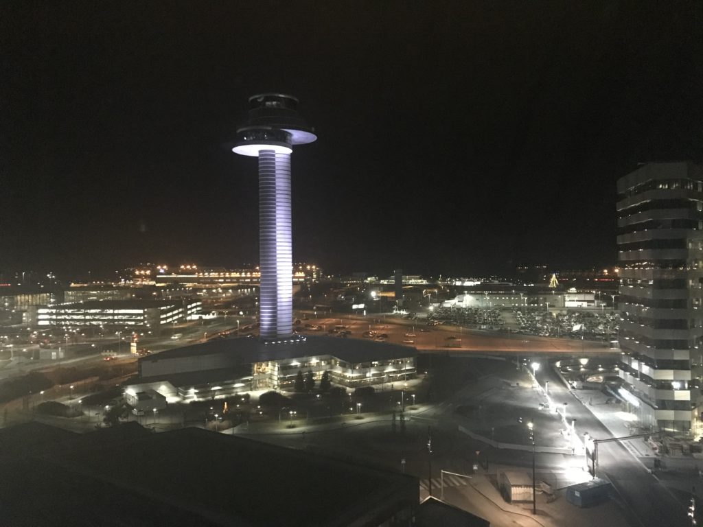 a tall tower with a round top at night