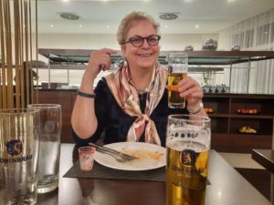 a woman holding a glass of beer