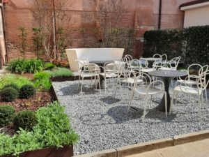 a small courtyard with tables and chairs