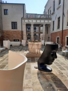 a statue of a face in a courtyard