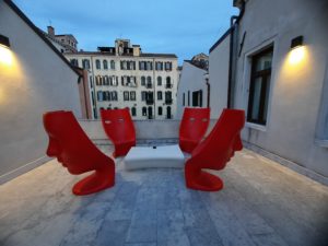a group of red chairs on a rooftop