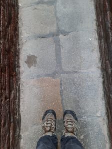 a person's feet on a stone surface
