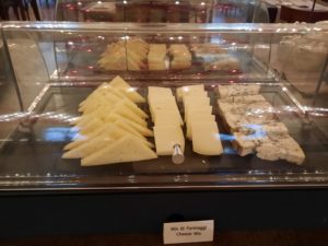 a display case with different types of cheese