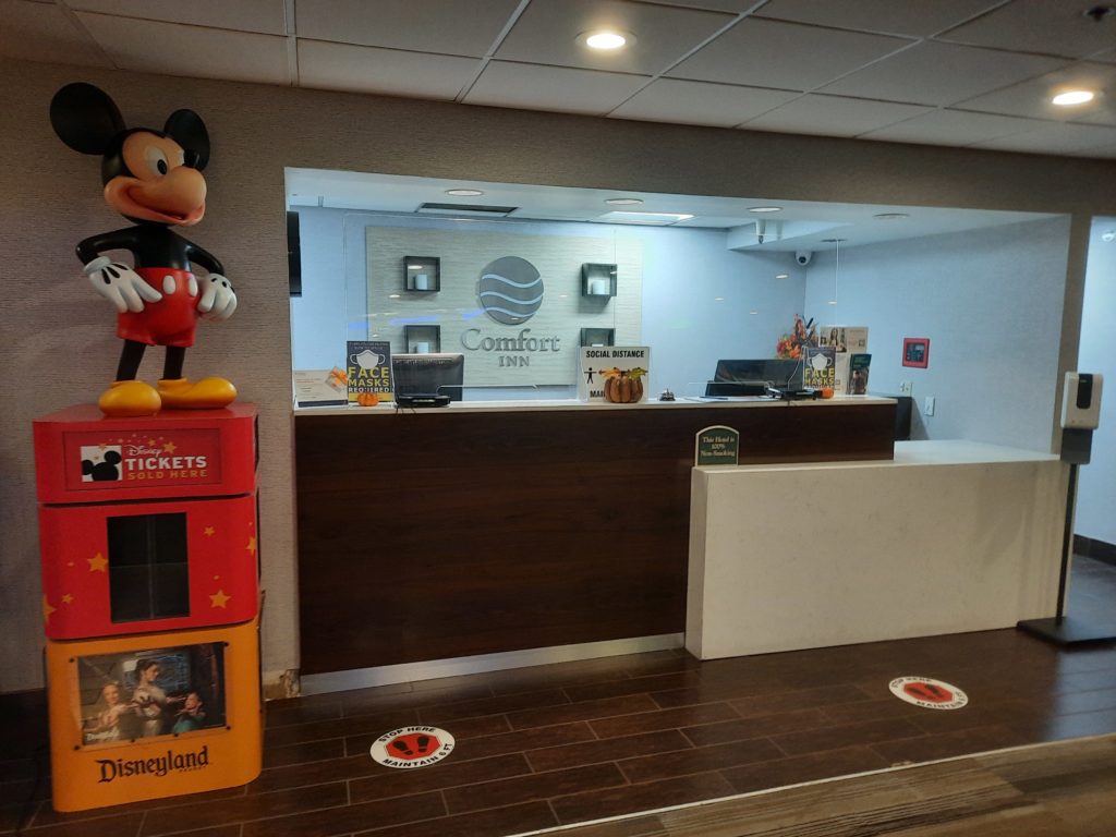 a hotel lobby with a cartoon character on top of a desk