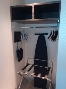 a swinger and clothes rack in a closet