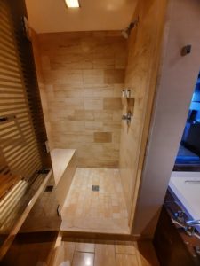 a shower with a bench