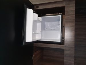 a black refrigerator with a white door