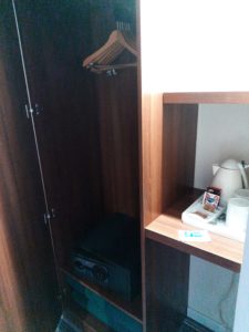 a closet with a shelf and a microwave