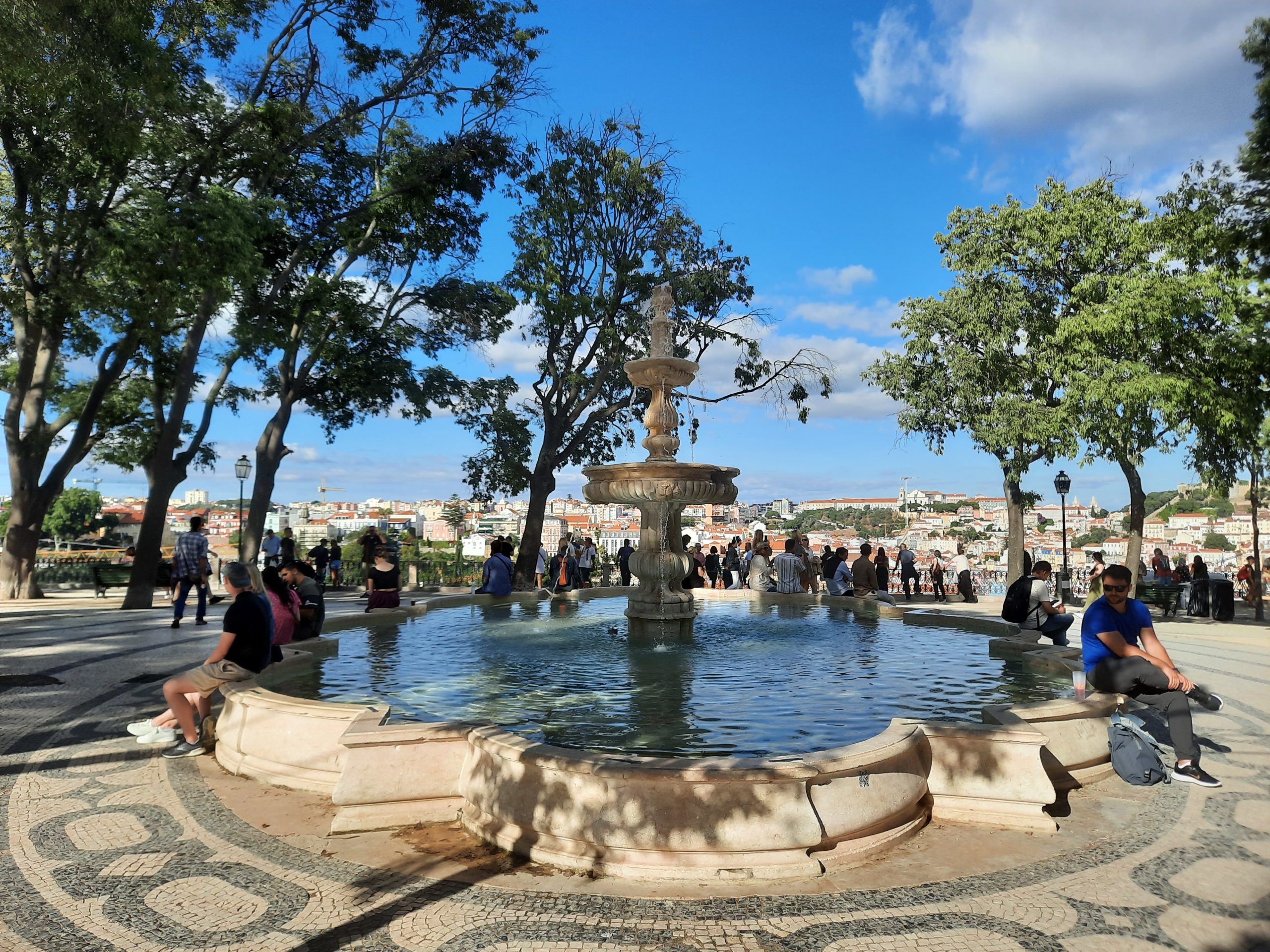 a fountain with people around it